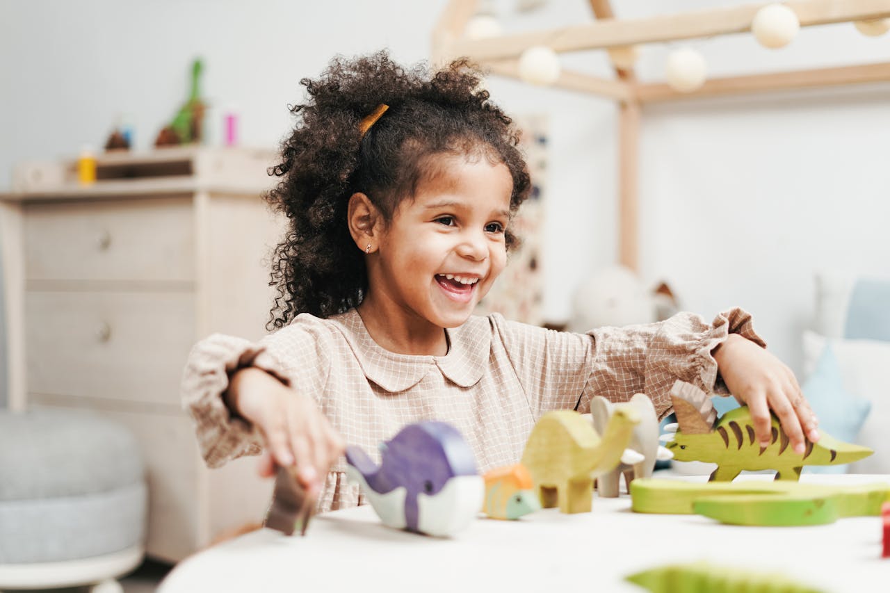Home A joyful young girl playing with wooden toys, showcasing pure childhood happiness.